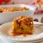 Pumpkin Bread Pudding on dessert plates with the casserole of bread pudding in the background.