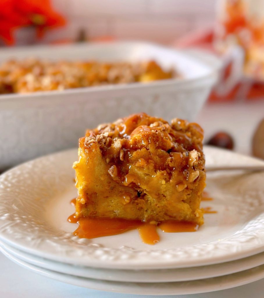 Pumpkin Bread Pudding on dessert plates with the casserole of bread pudding in the background.