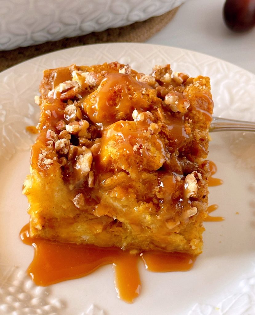 Pumpkin Bread Pudding with caramel sauce on a dessert plate.