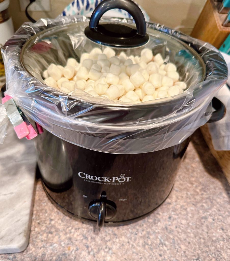 Lid on top of the slow cooker for the yams.