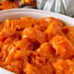 Close-up photo of Candied Yams in a white serving bowl.