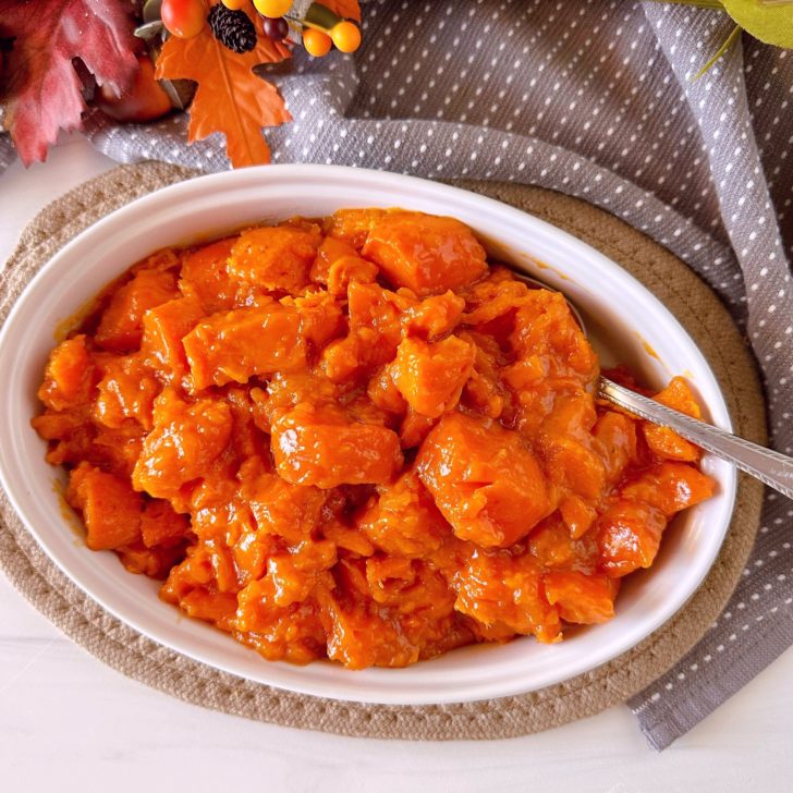 Slow Cooker Candied Yams in a white casserole dish.