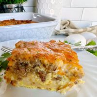 Layered Holiday Crescent Roll Breakfast Casserole serving on a white plate.