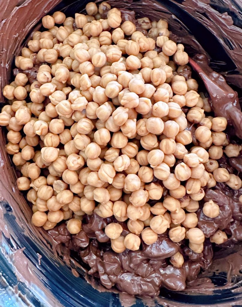 Caramel bits added to chocolate covered pecans.