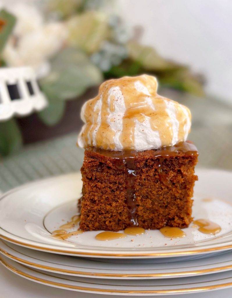 A slice of Gingerbread Cake with Caramel Sauce on a dessert plate.