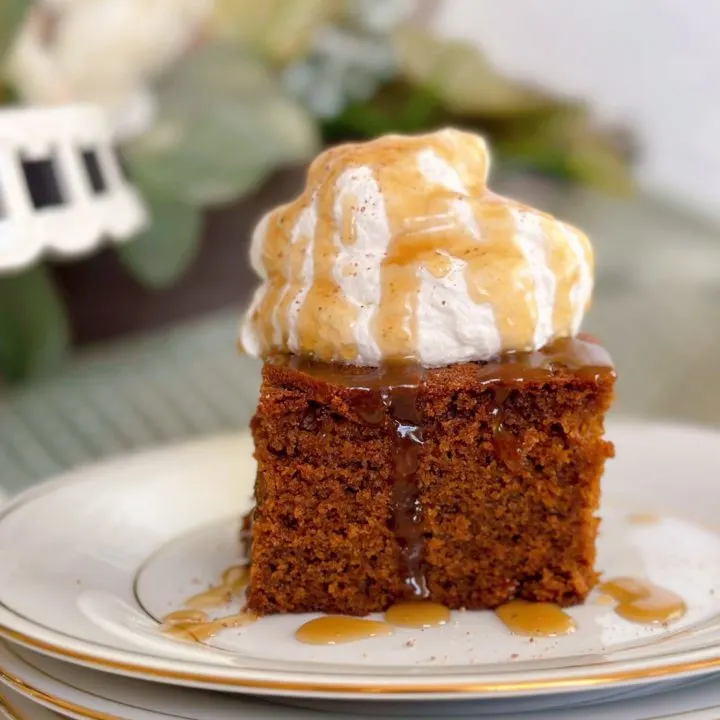 A slice of Gingerbread Cake with Caramel Sauce on a dessert plate.
