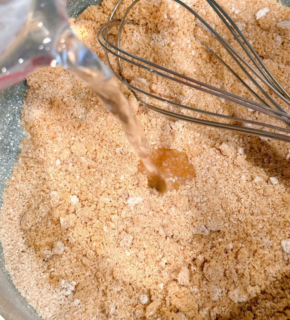 Adding water to brown sugar and cornstarch in saucepan.