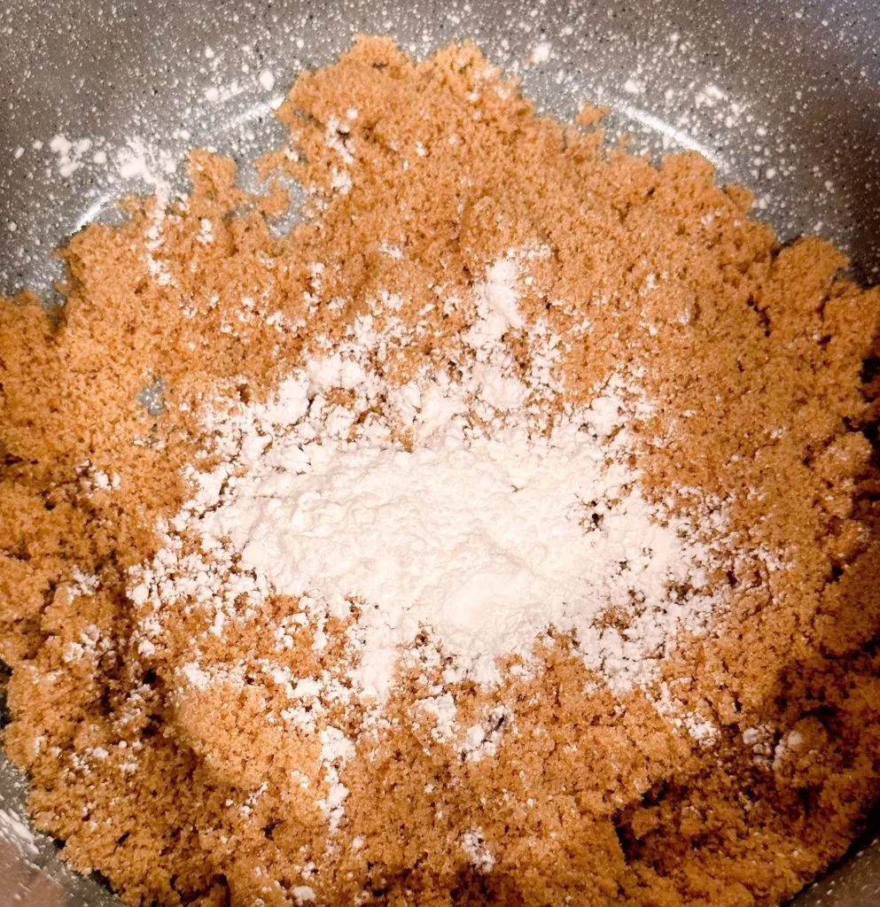 Brown sugar and cornstarch in a small sauce pan on the stove top.