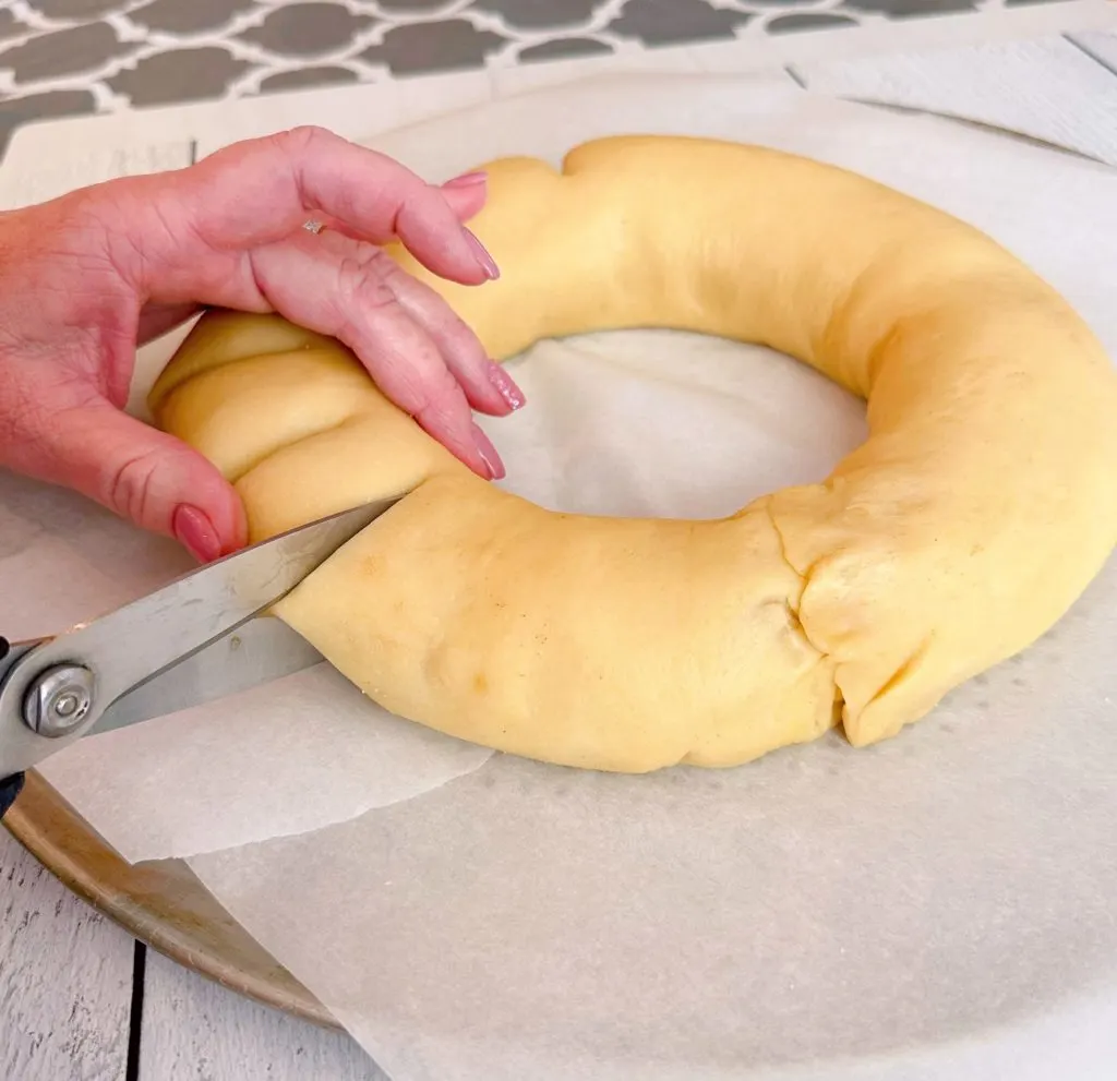 Cutting through the tea ring dough in one-inch intervals.