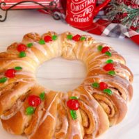 Swedish Tea Ring on a white board with beautiful decorations and a vanilla glaze.