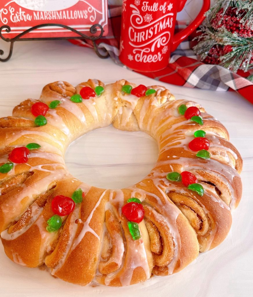 Swedish Tea Ring on a white board with beautiful decorations and a vanilla glaze.