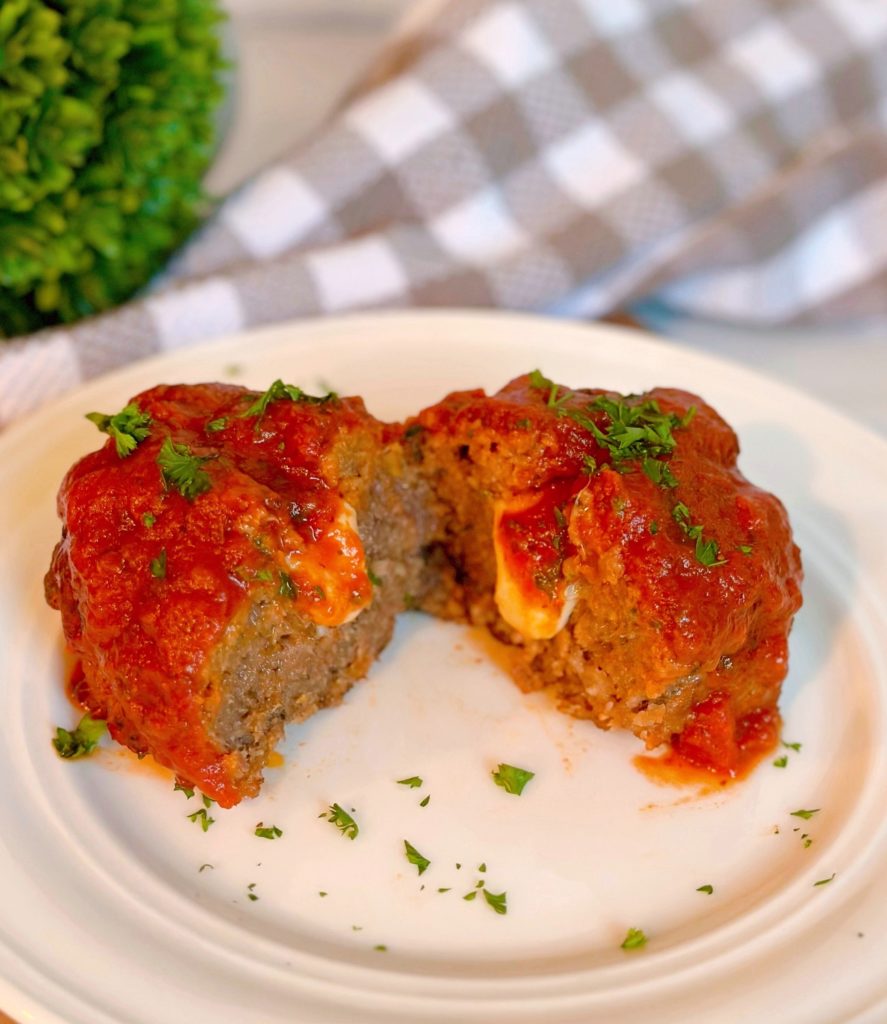 Individual Stuffed Italian Meatloaf cut in half with cheese oozing out!