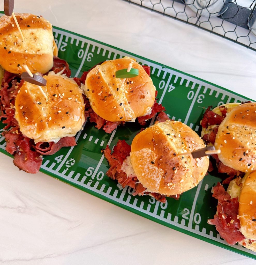 Football plate filled with Pastrami and Cheese Sliders.