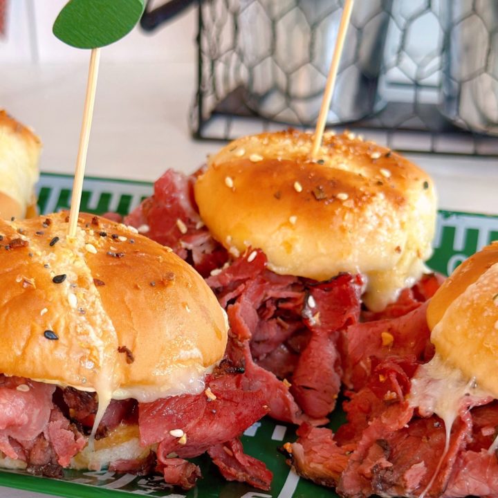 Hot Pastrami and Cheese sliders on a platter.