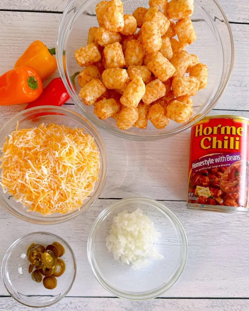 Ingredients on a white table for Tater Tot Chili Cheese Cup Bites.