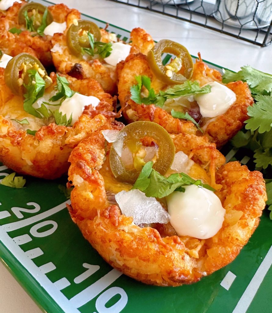 Tater Tot Chili Cheese Cup Bites on a fun Football platter for game day snacks.