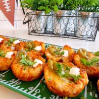 Tater Tot Chili bites with garnishes on serving platter.