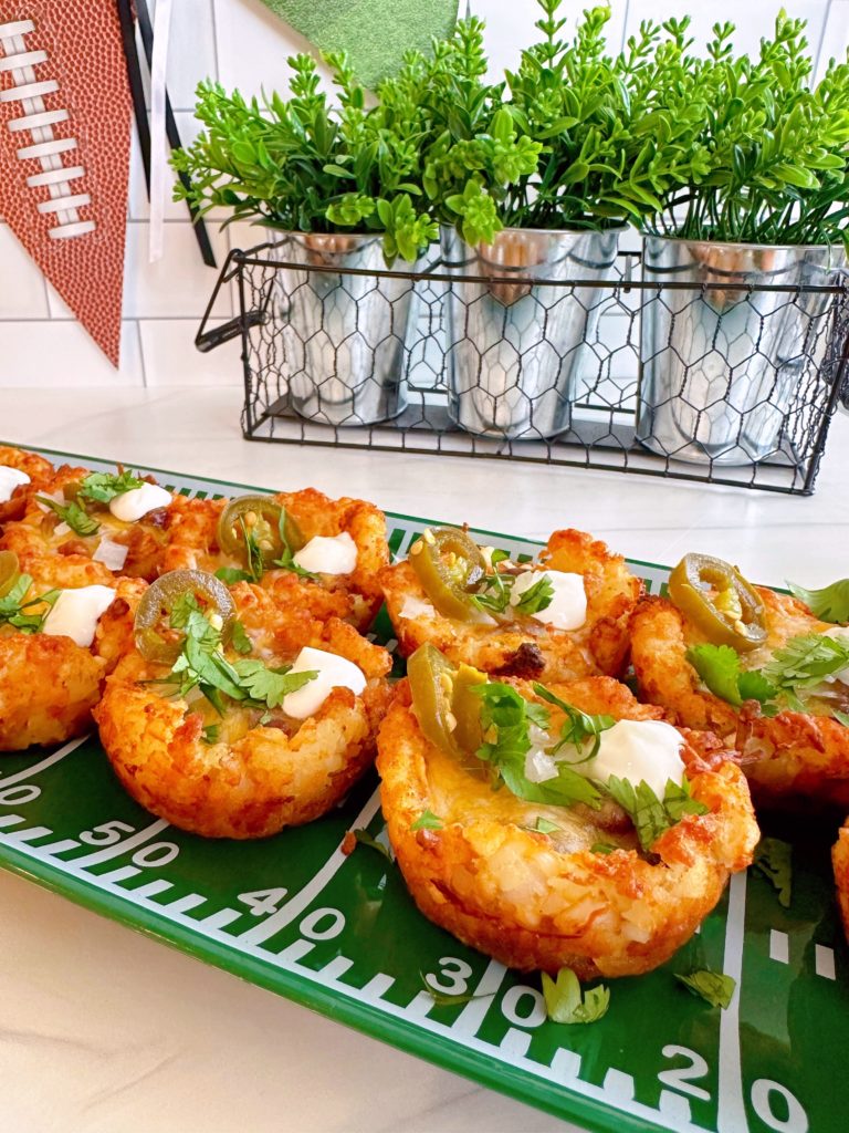 Tater Tot Chili bites with garnishes on serving platter.