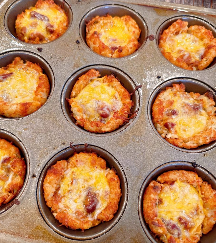 Melted cheese on top of each chili cheese cup.