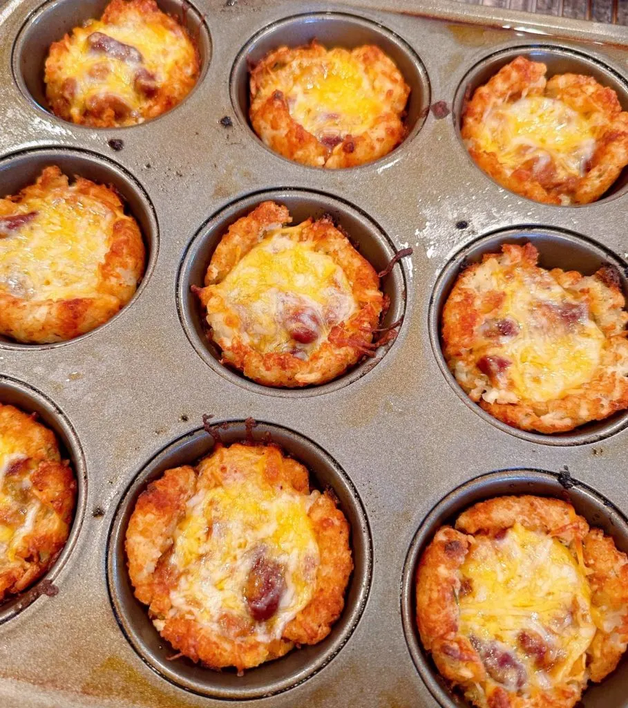 Melted cheese on top of each chili cheese cup.