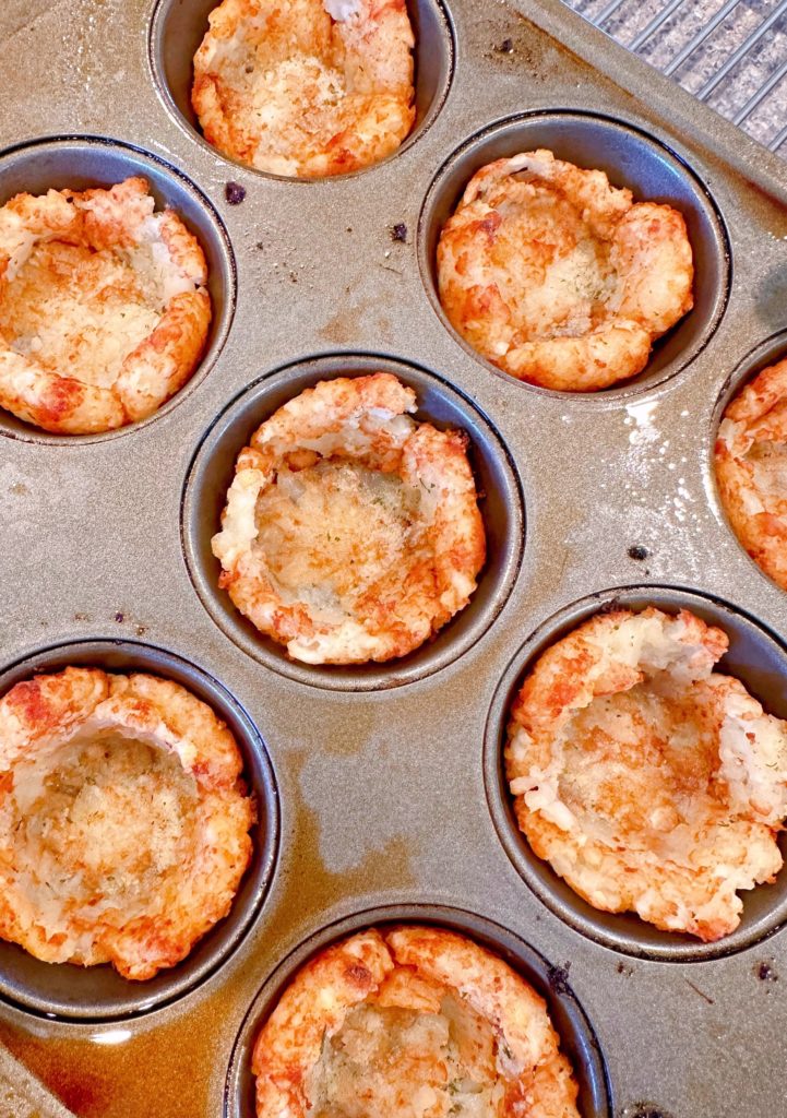 Baked Tater tot cups golden brown and in the muffin tin.