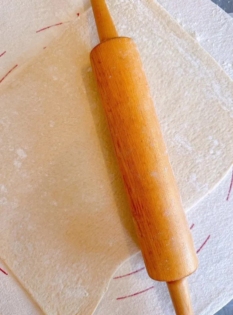 Refrigerated Pizza dough rolled out on a lightly floured board.