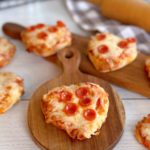 Baked Pizzas on mini cutting boards ready to eat.