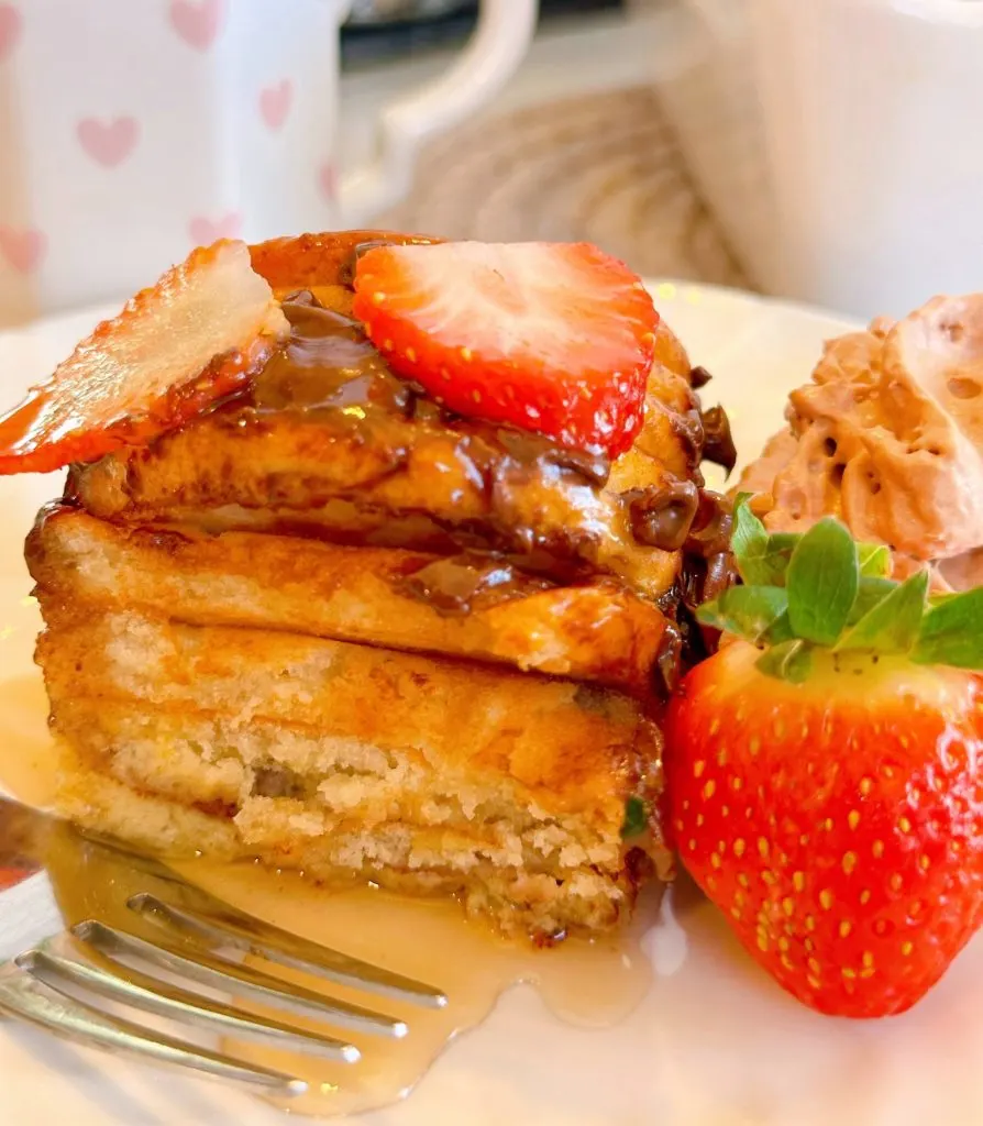 Serving of French Toast Casserole with maple syrup.