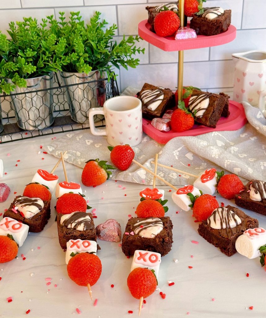 Counter top covered with Strawberry Brownie Marshmallow Valentine's Kabobs.