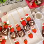 Strawberry Brownie Valentine Kabobs on a white platter.