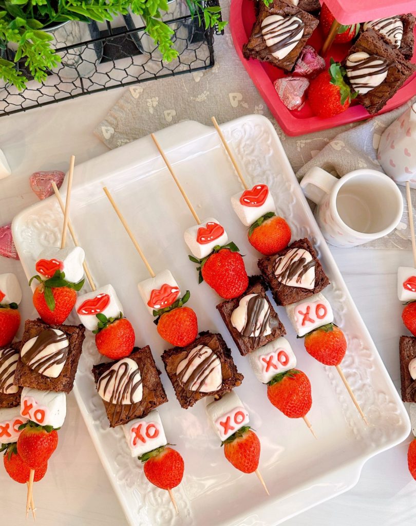 Strawberry Brownie Valentine Kabobs on a white platter.