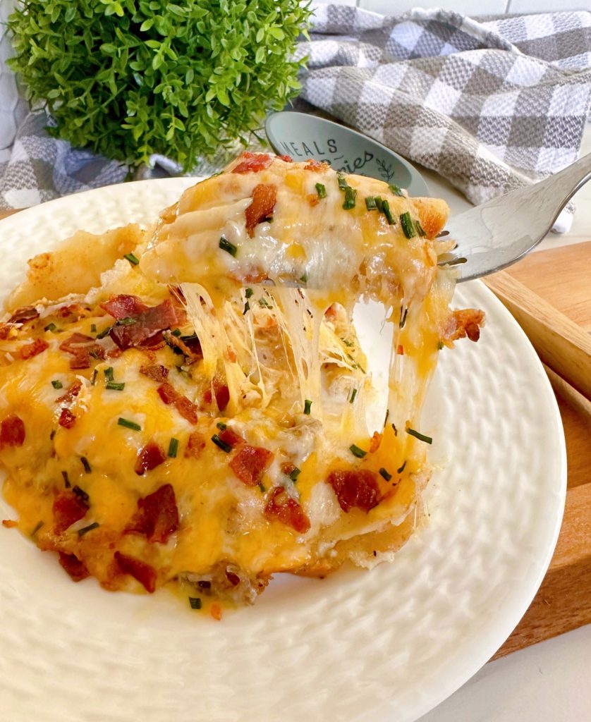 Easy Pierogi Casserole on a white dinner plate with a forkful!