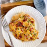 Serving of Pierogi Sausage Casserole on a white dinner plate.