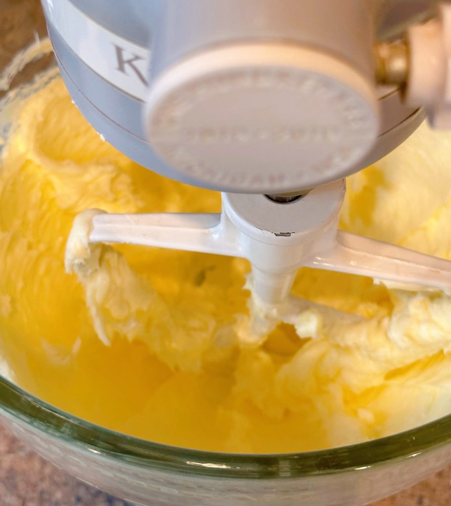 Creaming the butter in the bowl of the mixer.