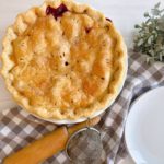 Baked Blackberry Pie on a table with a rolling pin.