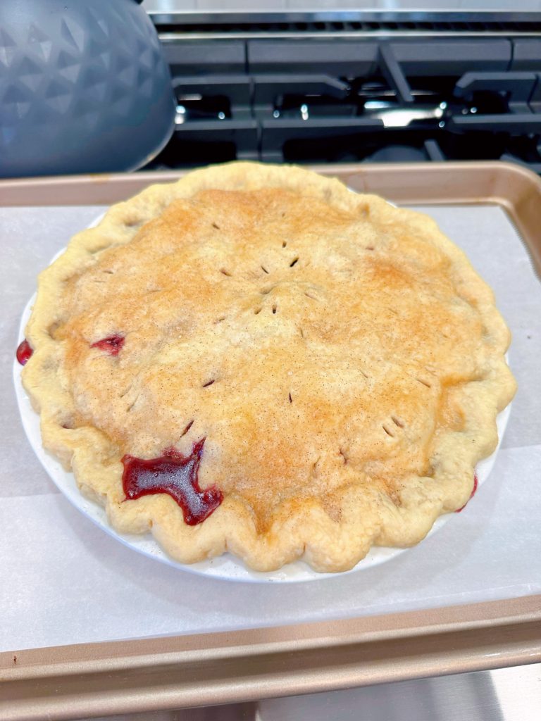 Blackberry Pie cooling on oven top after baking.