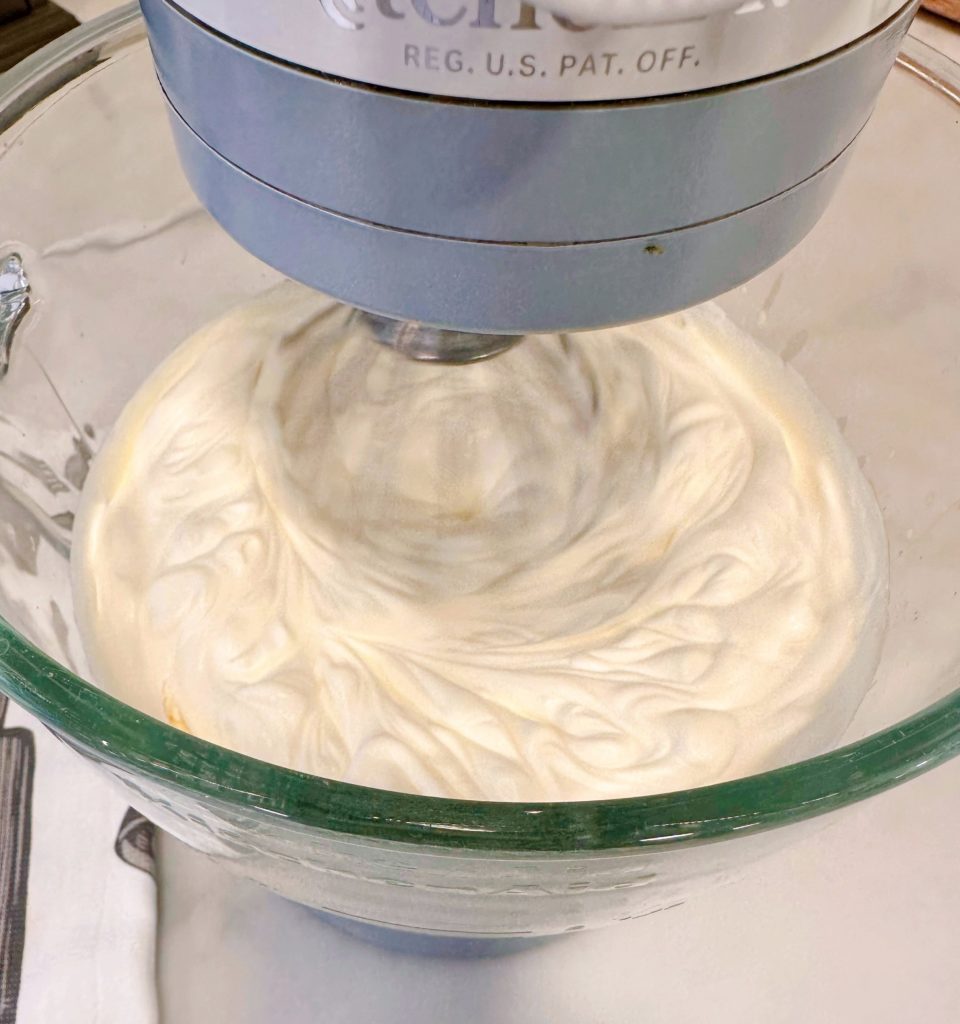 Mixing heavy whipping cream in mixer.