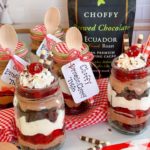 Individual Choffy Black Forest Trifles with bagged choffy in the background.