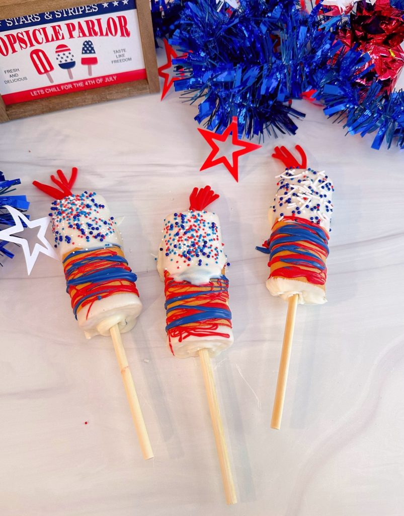 4th of July Firecracker Cake Pops on a white counter ready to eat.