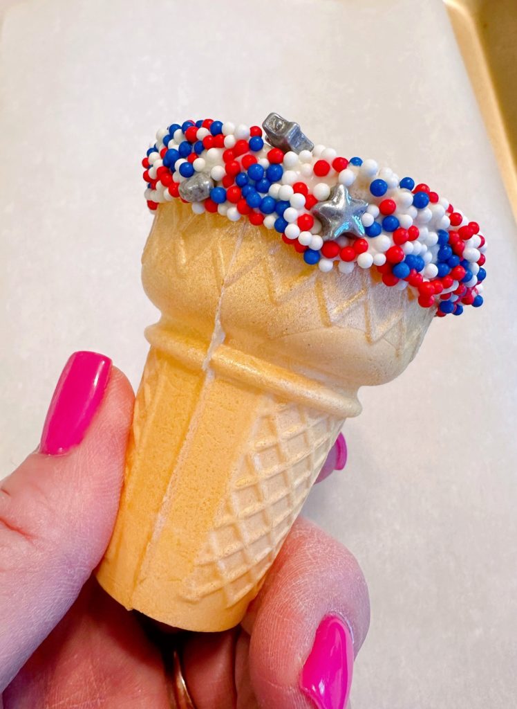 Cake Ice Cream Cone dipped in sprinkles.