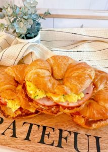 Easy Croissant Breakfast Sandwiches on a cutting board.
