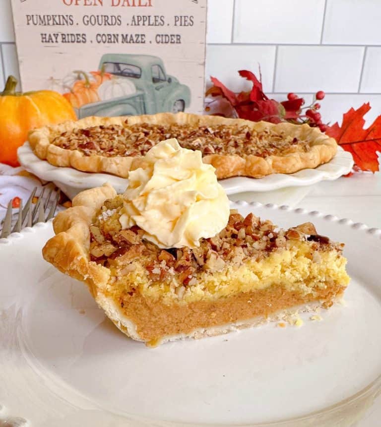 Pumpkin Crunch Pie sliced with a dollop of whipped cream.
