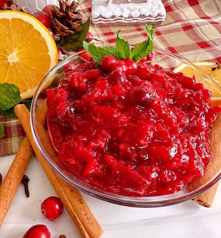 Cranberry Pear Chutney Recipe in a serving dish surrounded by spices.