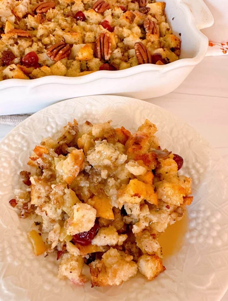 Sausage Cranberry Sourdough Stuffing with gravy on a serving plate.