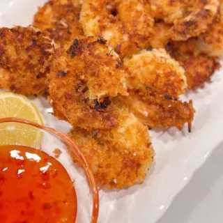 Coconut shrimp piled high on a plate.