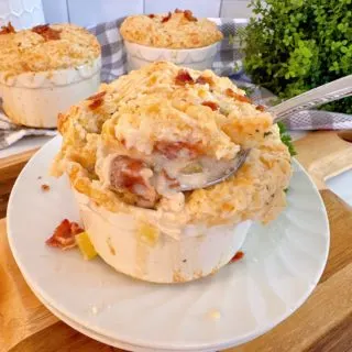 Chicken, Bacon, Cheddar Bay Biscuit Soup with a heaping spoonful lifted out of the bowl.