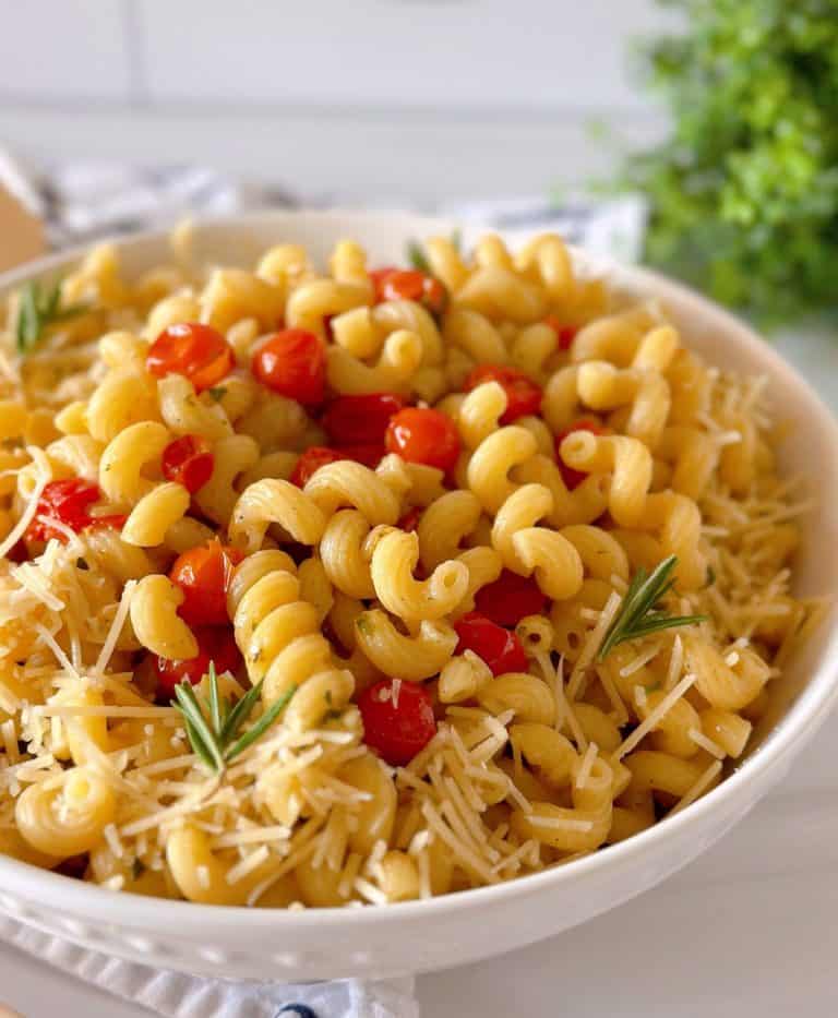 Fresh Tomatoes and Basil with Pasta in a white bowl and fresh Parmesan cheese.