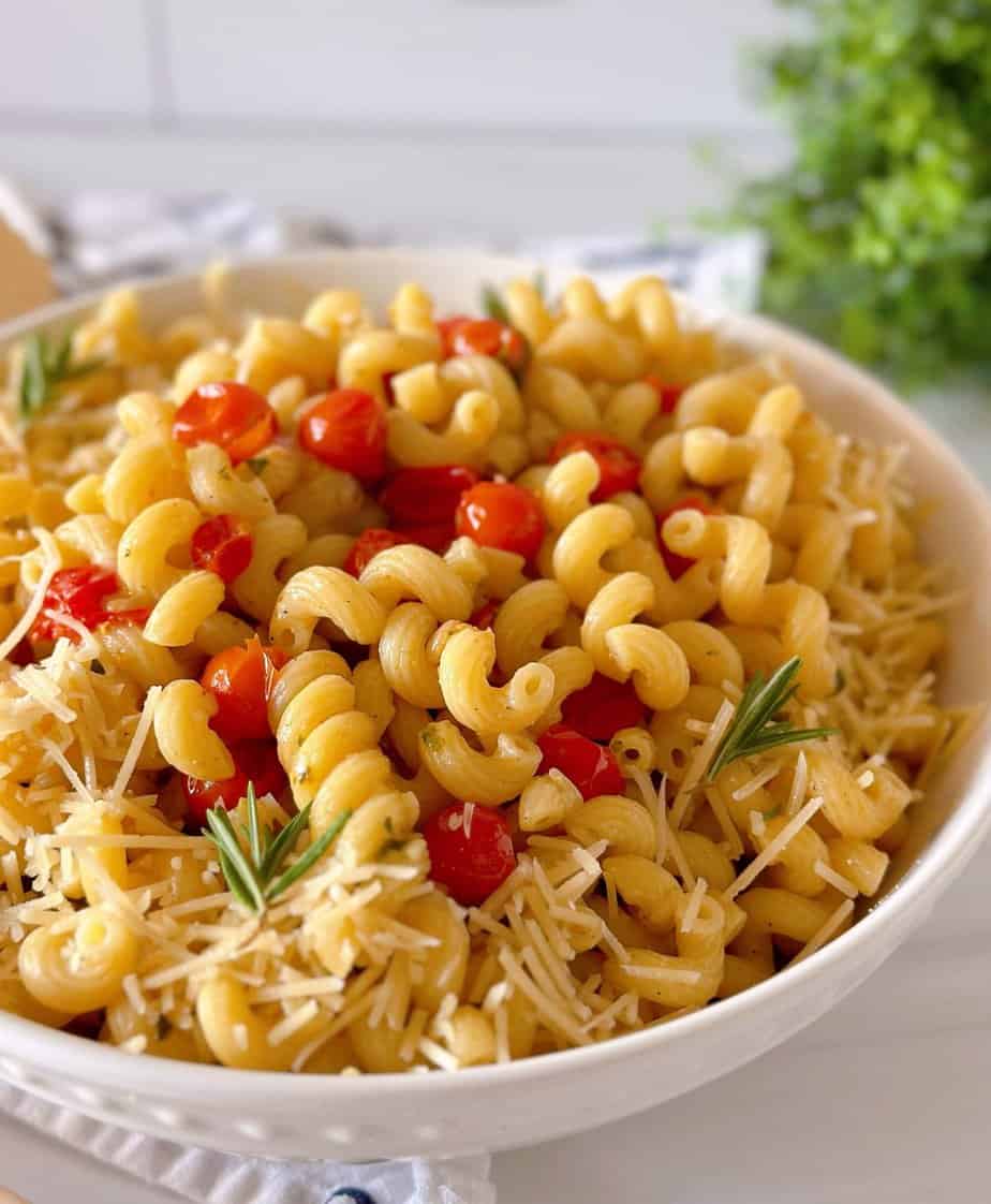 Fresh Tomatoes and Basil with Pasta in a white bowl and fresh Parmesan cheese.