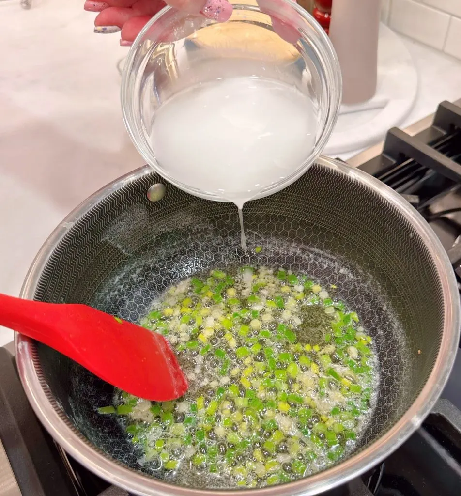 Adding cornstarch mixture to butter and green onions.