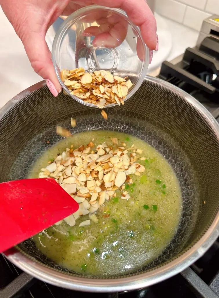 Stirring in the almonds.
